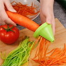 Manual cucumber spiralizer tool making vegetable noodles over a plate